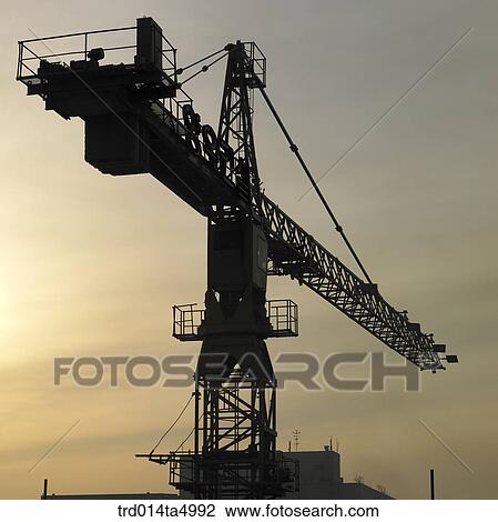at a construction place, a crane with the glow of the setting sun View Large Photo Image Stock Image - at a construction place, a crane with the glow of the setting sun. Fotosearch