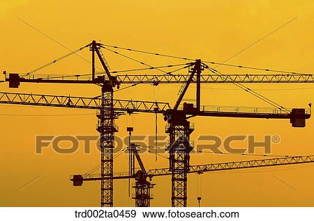 at a construction place, a crane with the glow of the setting sun View Large Photo Image Stock Photo - at a construction place, a crane with the glow of the setting sun. Fotosearch