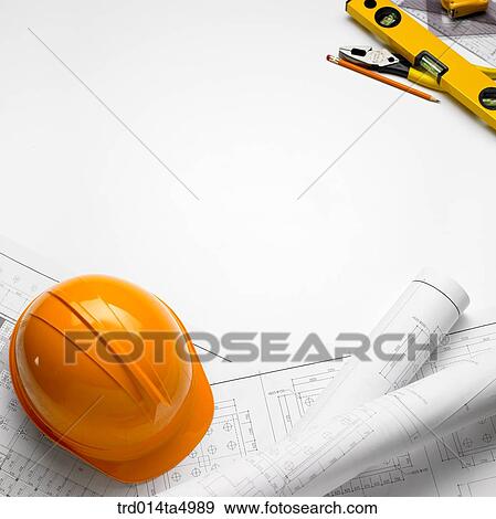 construction, a plan and a safety hat on a desk View Large Photo Image Stock Photo - construction, a plan and a safety hat on a desk. Fotosearch