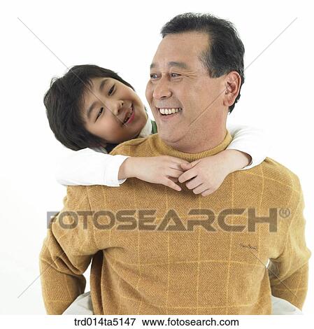 Family/ a grandfather carrying his grandson on his back View Large Photo Image Stock Photo - Family/ a grandfather carrying his grandson on his back. Fotosearch