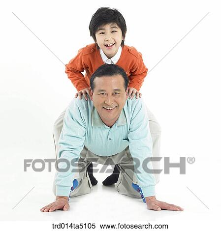 Stock Photography - Family/ a grandfather giving a grandson a back. Fotosearch