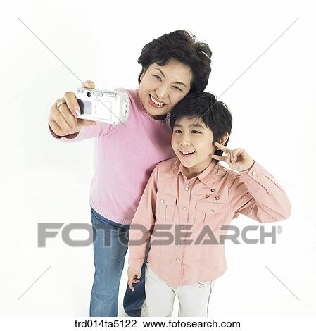Stock Image - Family/ a grandmother and her grandson taking pictures. Fotosearch
