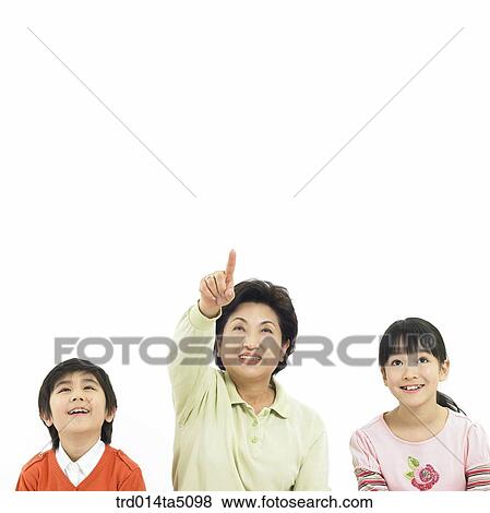 Family/ a grandmother and her grandson and granddaughter pointing at something View Large Photo Image Stock Photo - Family/ a grandmother and her grandson and granddaughter pointing at something. Fotosearch
