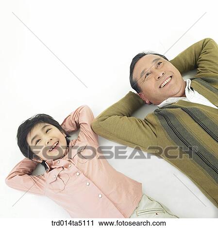 Stock Image - Family/ A grandson resting his head on his grandfather's elbow. Fotosearch