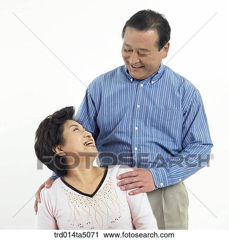 Stock Image - Family/ an friendly facing old couple. Fotosearch