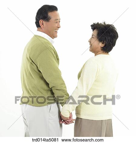 Stock Image - Family/ an friendly facing old couple. Fotosearch