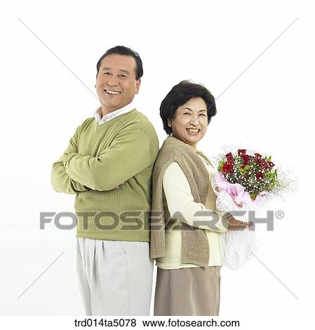 Family/ an old couple holding a bouquet View Large Photo Image Stock Photo - Family/ an old couple holding a bouquet. Fotosearch