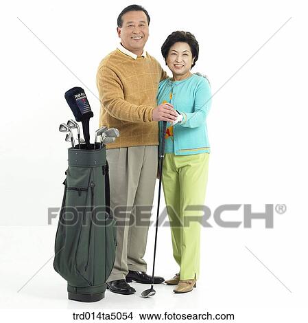 Family/ an old couple holding a golf club View Large Photo Image Picture - Family/ an old couple holding a golf club. Fotosearch