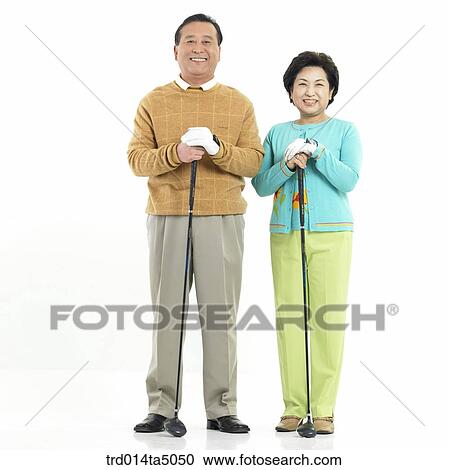 Stock Image - Family/ an old couple holding a golf club. Fotosearch