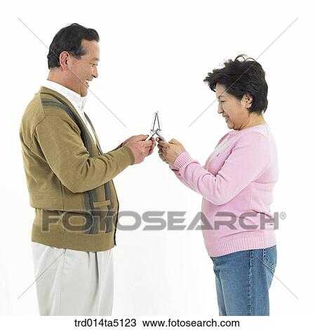 Family/ an old couple holding their mobile phones View Large Photo Image Stock Image - Family/ an old couple holding their mobile phones. Fotosearch