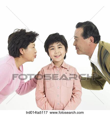 Stock Photo - Family/ grandparents kissing their grandson. Fotosearch
