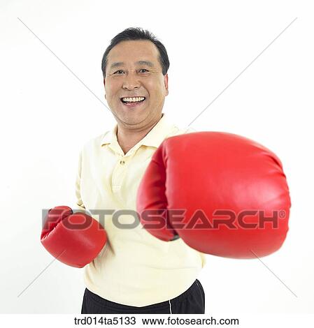 Stock Image - The old/ a punching man wearing boxing gloves. Fotosearch