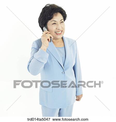 Stock Photo - The old/ A woman talking on a mobile phone. Fotosearch