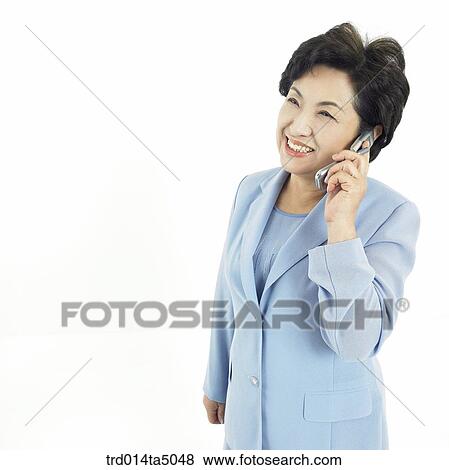 The old/ A woman talking on a mobile phone View Large Photo Image Stock Photo - The old/ A woman talking on a mobile phone. Fotosearch