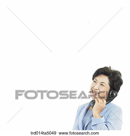 Stock Photo - The old/ A woman talking on a phone. Fotosearch