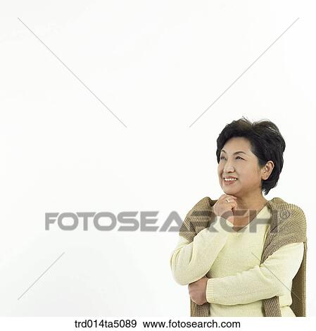 Stock Photo - The old/ a woman with her chin resting on the hand. Fotosearch