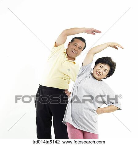 Stock Image - The old/ an old couple warming up. Fotosearch