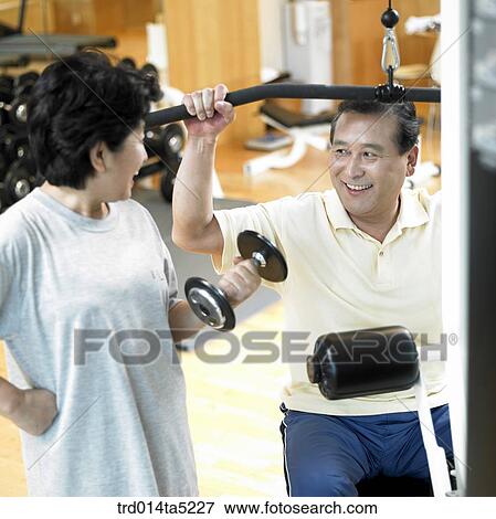 an exercising old couple at a fitness club View Large Photo Image Stock Photo - an exercising old couple at a fitness club. Fotosearch