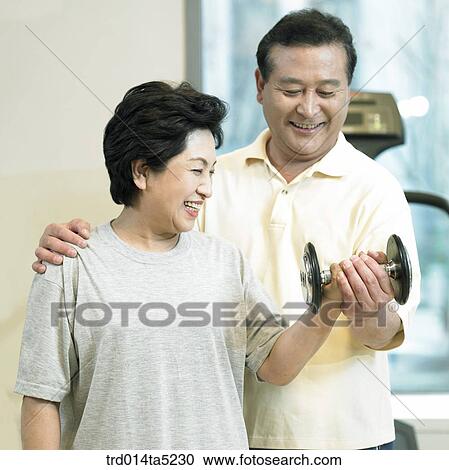 an exercising old couple with dumbbells at a fitness club View Large Photo Image Stock Image - an exercising old couple with dumbbells at a fitness club. Fotosearch