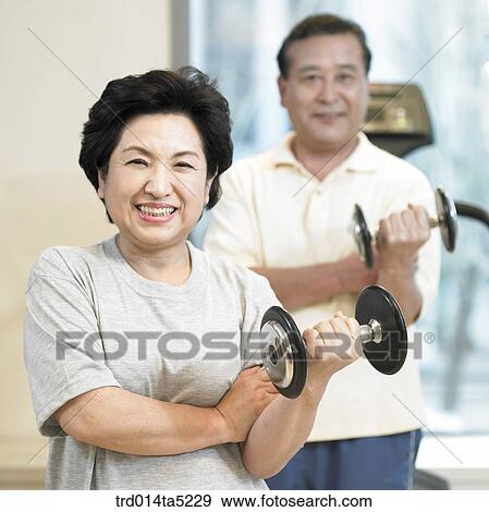 an exercising old couple with dumbbells at a fitness club View Large Photo Image Stock Photo - an exercising old couple with dumbbells at a fitness club. Fotosearch