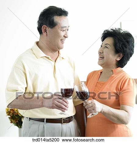 an old couple drinking wine on a bed View Large Photo Image Stock Image - an old couple drinking wine on a bed. Fotosearch