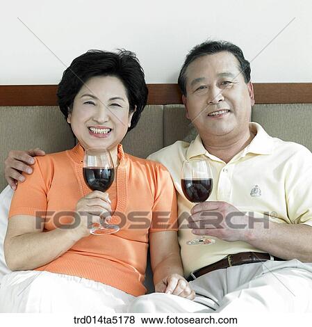 an old couple drinking wine on a bed View Large Photo Image Stock Photo - an old couple drinking wine on a bed. Fotosearch