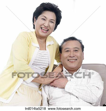 Stock Photo - an old couple holding each other's hands. Fotosearch