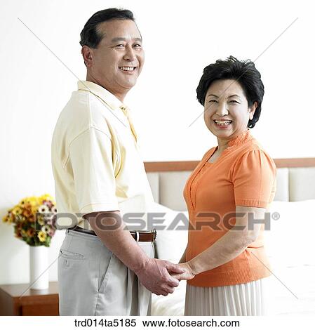 Stock Photography - an old couple holding each other's hands. Fotosearch