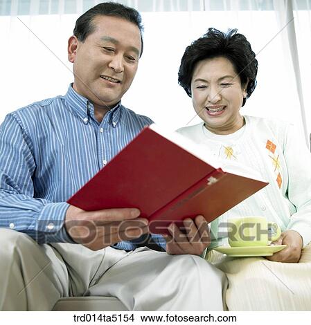 Picture - an old couple on a sofa. Fotosearch