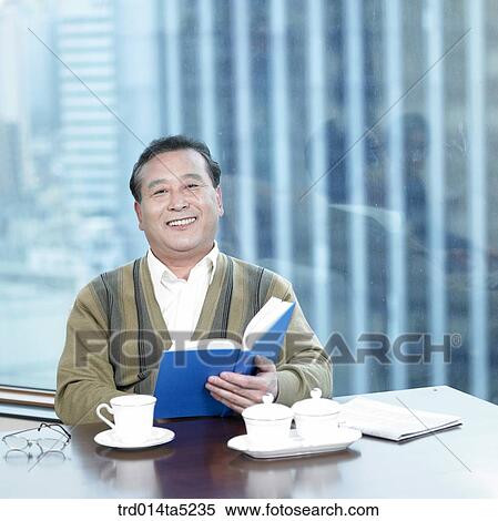 an old man reading a book and drinking a cup of tea View Large Photo Image Stock Photography - an old man reading a book and drinking a cup of tea. Fotosearch