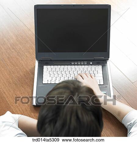 Stock Photo - a back working with a notebook. Fotosearch