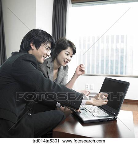 a businessman and a businesswoman with a notebook View Large Photo Image Stock Image - a businessman and a businesswoman with a notebook. Fotosearch
