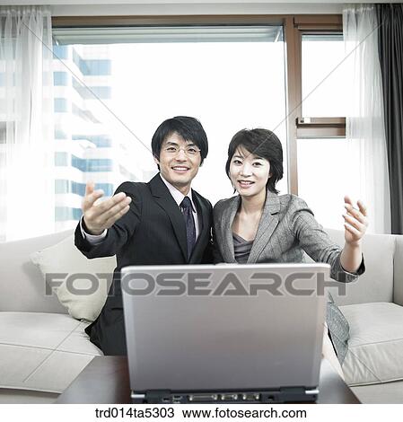 a businessman and a businesswoman with a notebook View Large Photo Image Stock Image - a businessman and a businesswoman with a notebook. Fotosearch