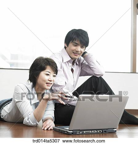 a businessman and a businesswoman with a notebook View Large Photo Image Stock Photo - a businessman and a businesswoman with a notebook. Fotosearch