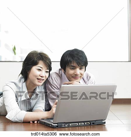 a businessman and a businesswoman with a notebook View Large Photo Image Stock Photograph - a businessman and a businesswoman with a notebook. Fotosearch