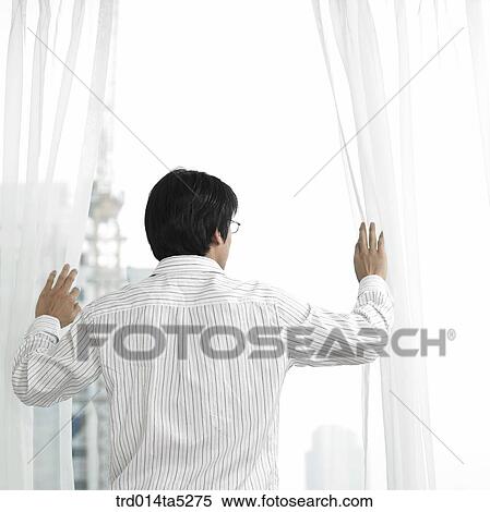 a businessman by a window View Large Photo Image Stock Photography - a businessman by a window. Fotosearch