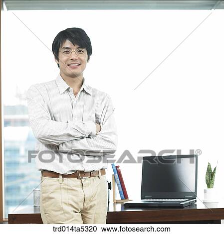 a businessman in front of a desk View Large Photo Image Stock Image - a businessman in front of a desk. Fotosearch