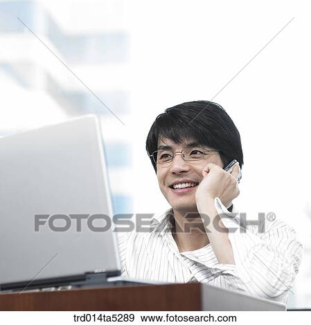 a businessman talking on a mobile phone View Large Photo Image Stock Photo - a businessman talking on a mobile phone. Fotosearch