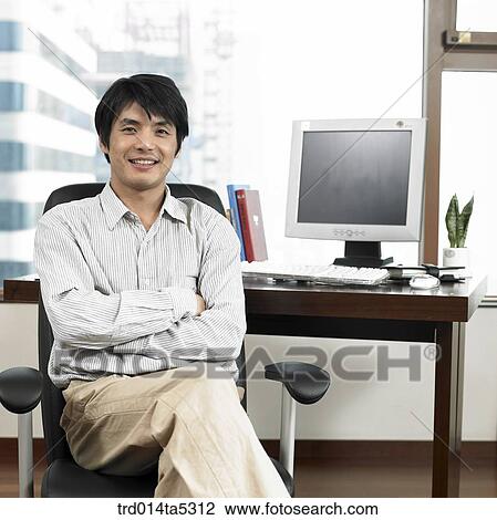 a businessman with his arms folded on a chair View Large Photo Image Stock Image - a businessman with his arms folded on a chair. Fotosearch