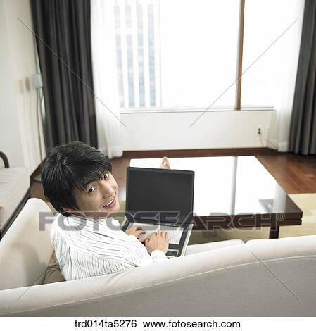 Stock Photograph - a businessman working with a notebook. Fotosearch