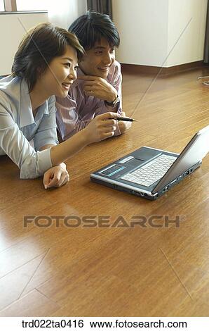 a businesswoman and a businessman working with a notebook View Large Photo Image Stock Photograph - a businesswoman and a businessman working with a notebook. Fotosearch