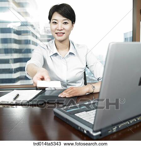 Stock Image - a businesswoman giving her namecard. Fotosearch
