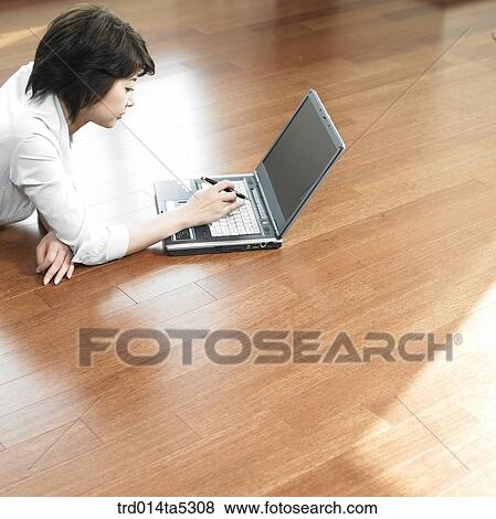 a businesswoman with a notebook on a floor View Large Photo Image Stock Photo - a businesswoman with a notebook on a floor. Fotosearch