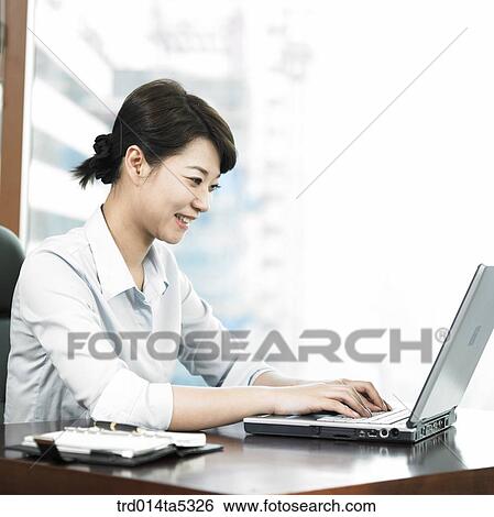 a businesswoman working with a notebook View Large Photo Image Stock Photograph - a businesswoman working with a notebook. Fotosearch