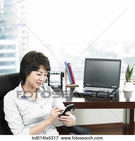 a businesswoman working with a PDA View Large Photo Image Stock Photo - a businesswoman working with a PDA. Fotosearch