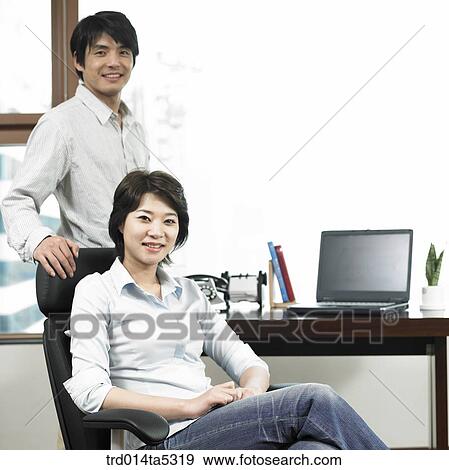 a busineswoman and a businessman on a chair View Large Photo Image Stock Photo - a busineswoman and a businessman on a chair. Fotosearch
