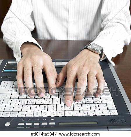 Stock Photo - a hand working with a notebook. Fotosearch