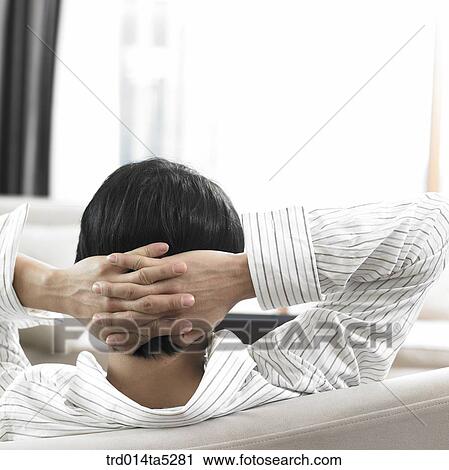 a man leaning on a sofa View Large Photo Image Stock Image - a man leaning on a sofa. Fotosearch