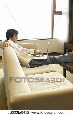 a man on a sofa View Large Photo Image Stock Image - a man on a sofa. Fotosearch