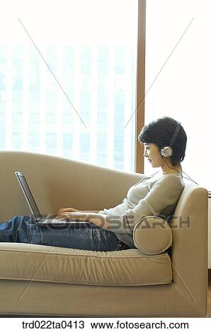 Stock Image - a woman on a sofa. Fotosearch
